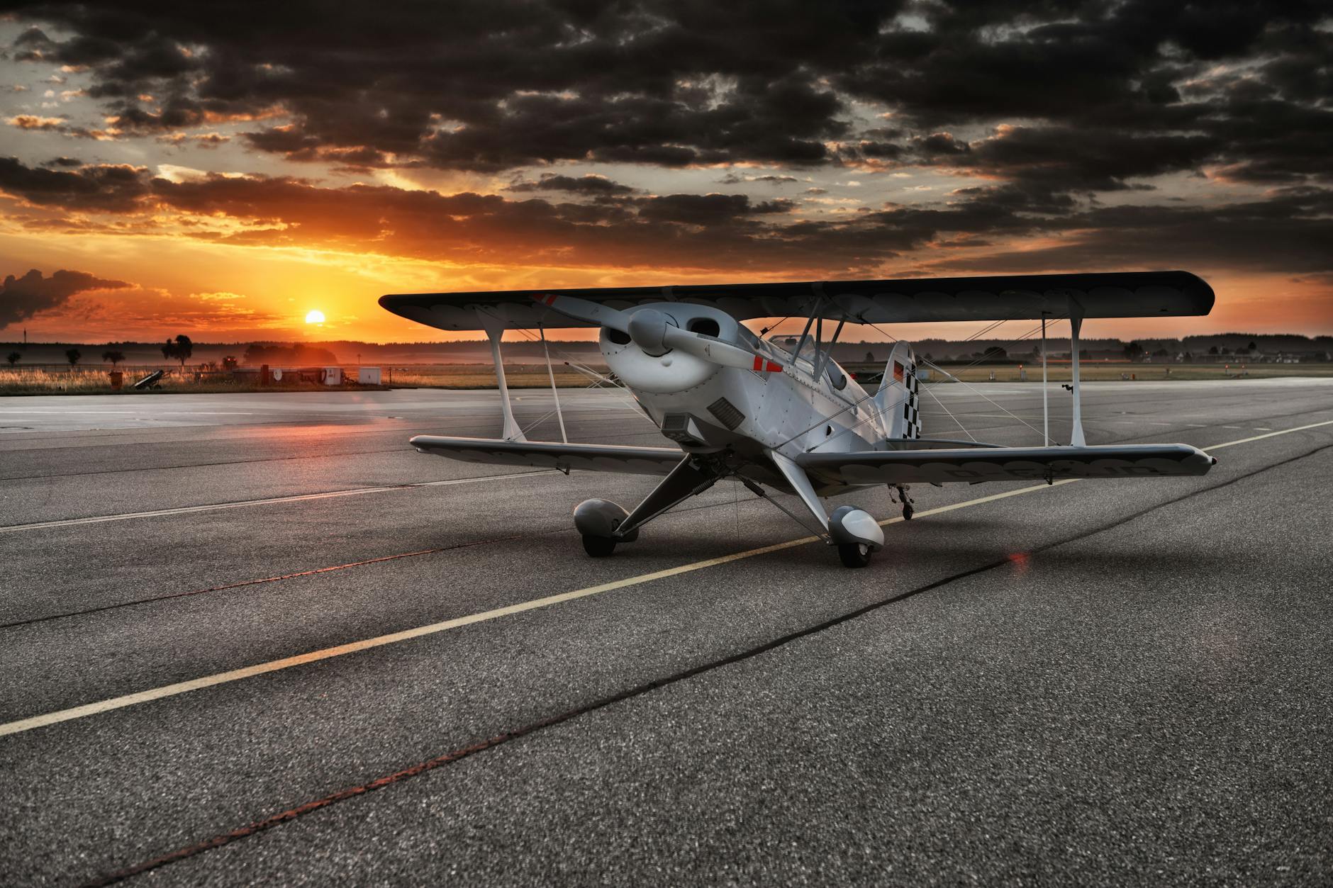 black and white aviation plane arriving during sunset