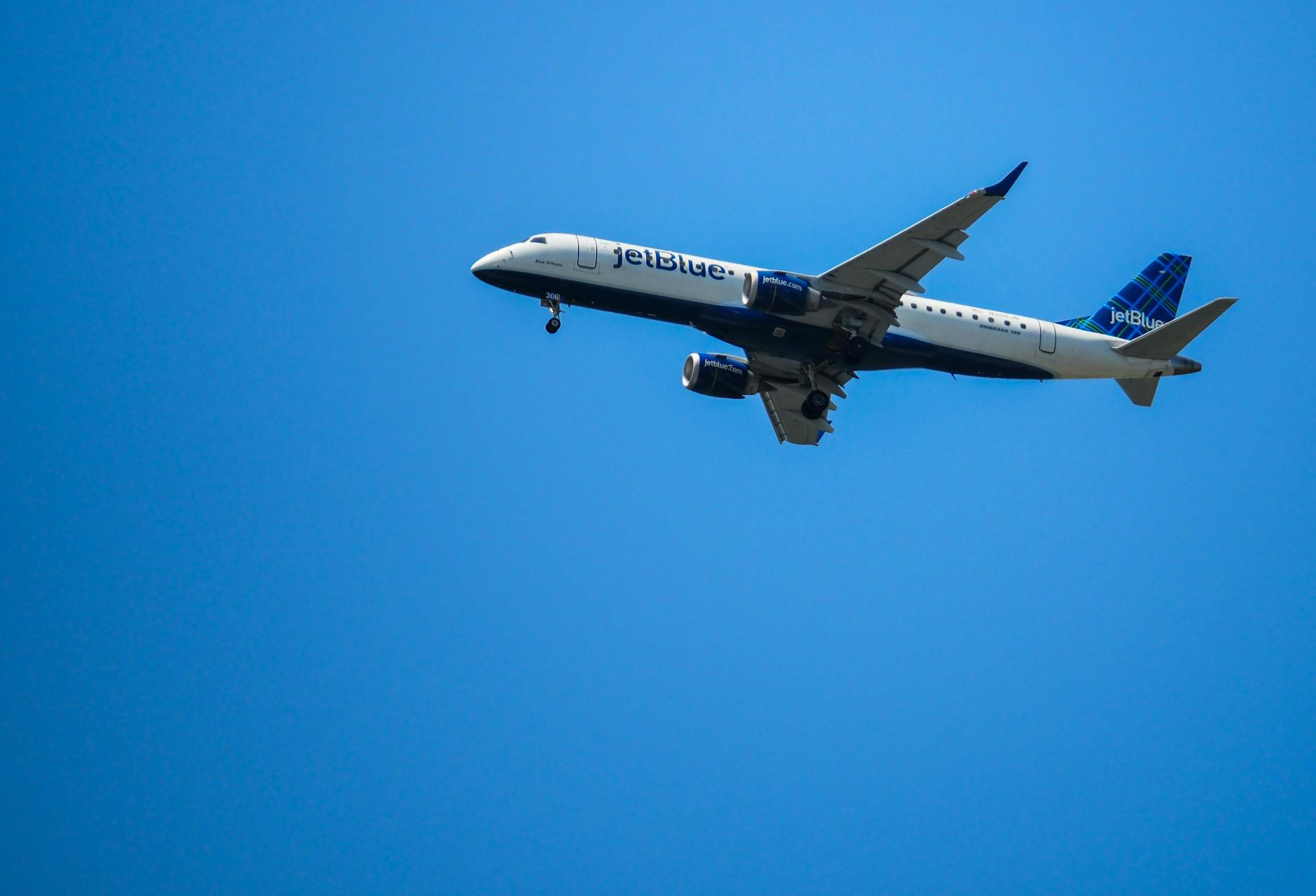 commercial jet airplane in clear blue sky