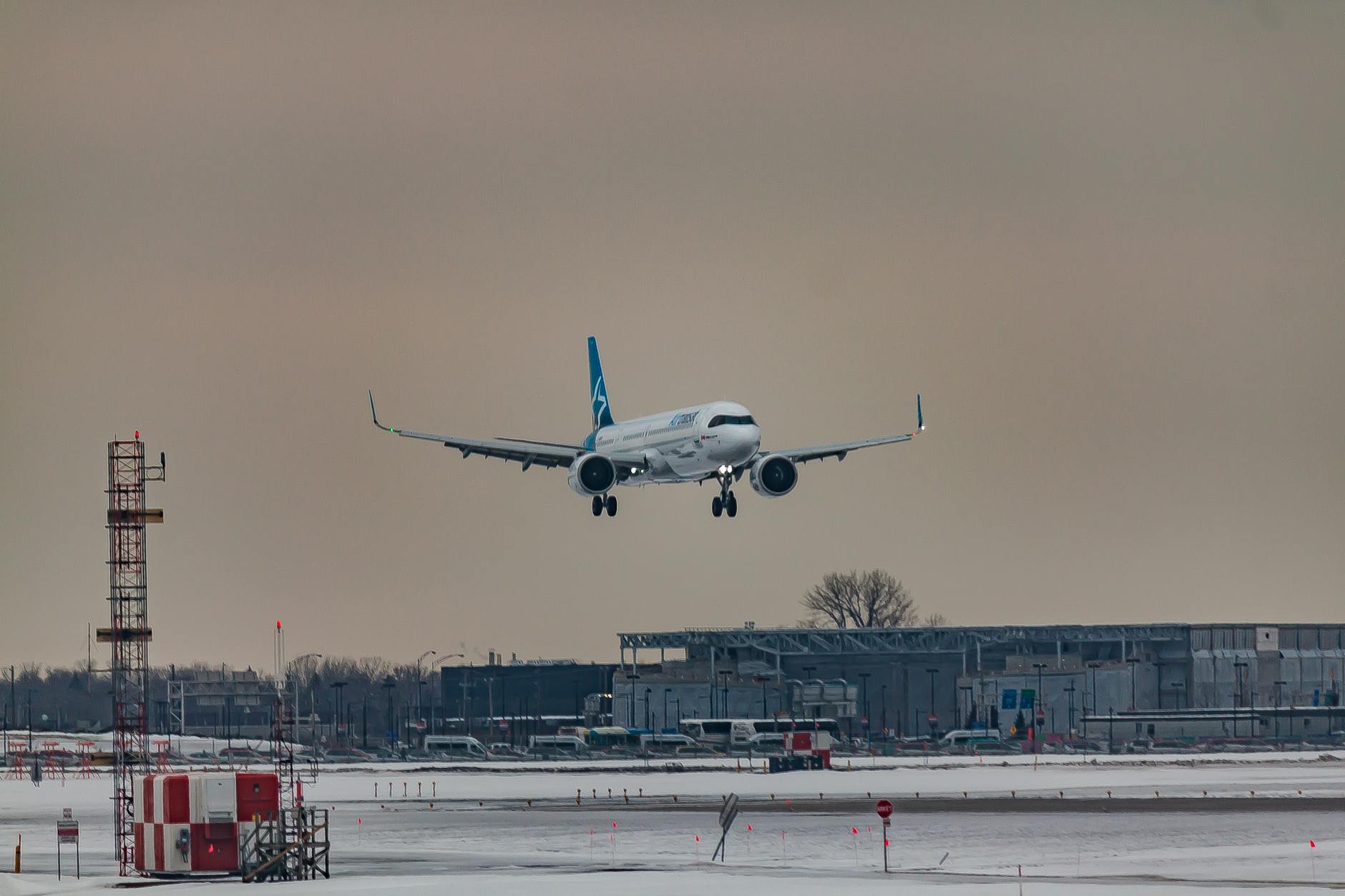 plane flying over airfield before arrival