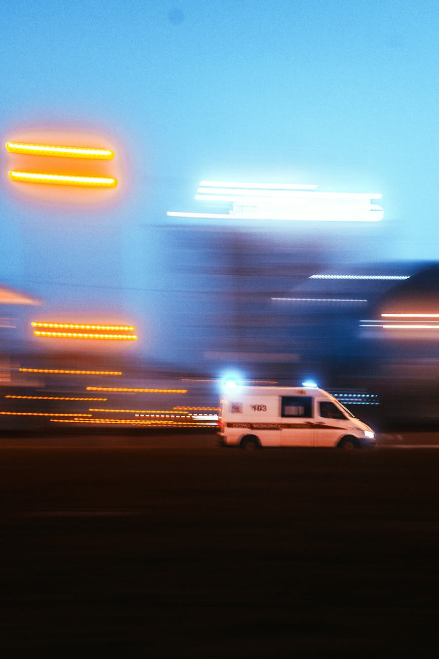 speeding ambulance at night with light trails