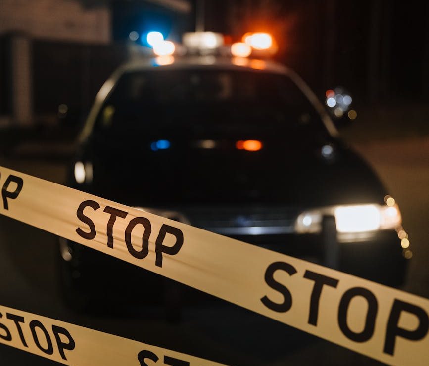 yellow crime tape against police car