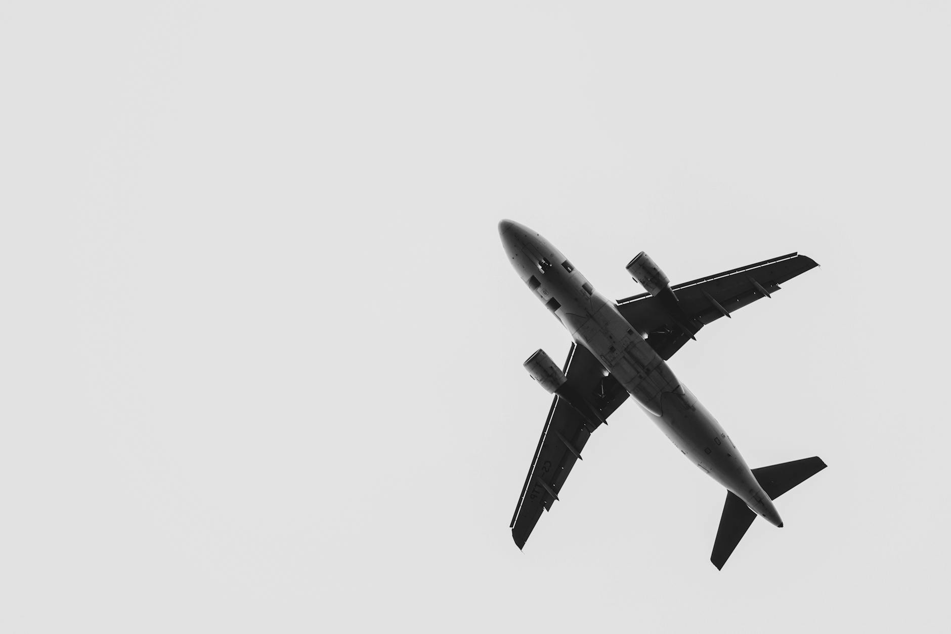 bottom view of plane flying through sky